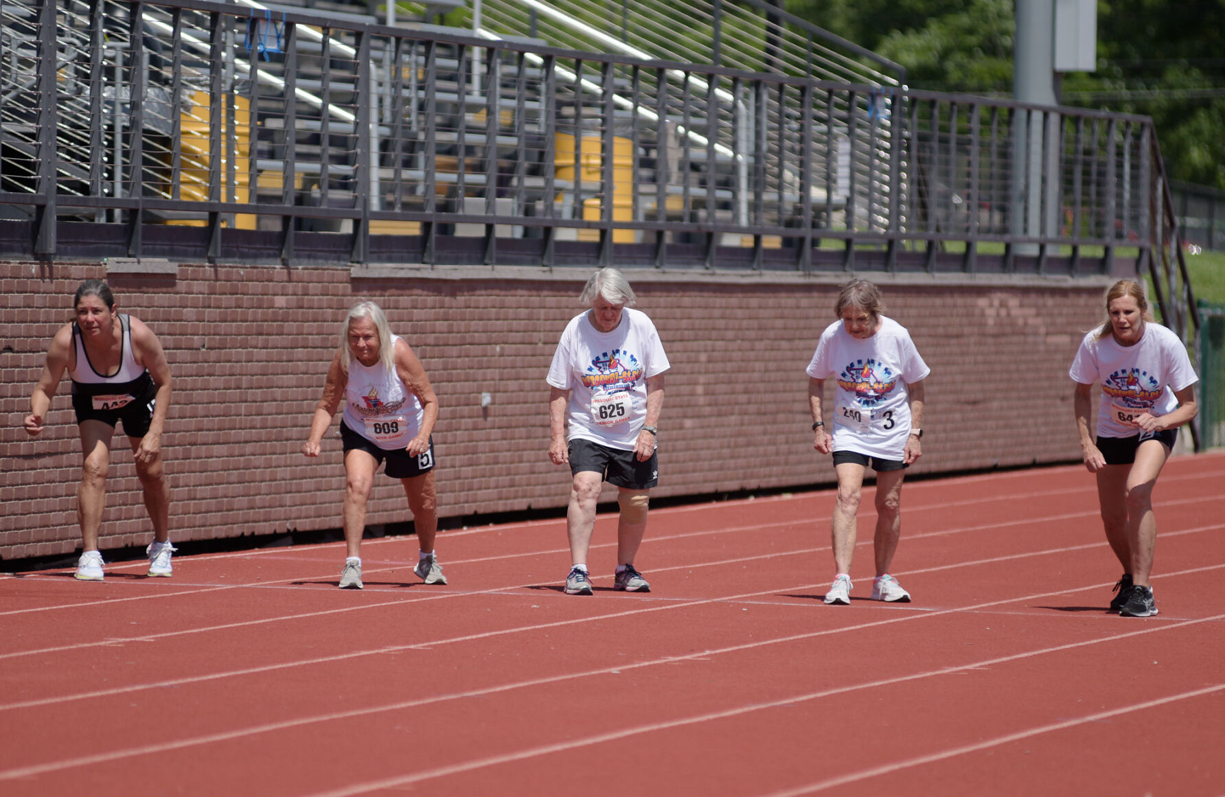 Athletes prepare to run the 50 meter dash